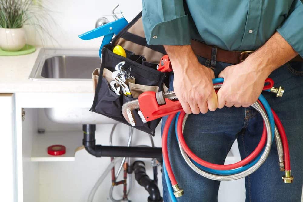 A Black Diamond Expert plumber stands ready with tools in hand, symbolizing 24/7 trustworthy home comfort and repair service.