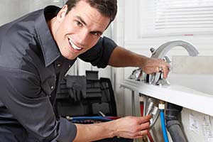 Skilled technician repairs plumbing under a sink, ensuring safe, reliable home comfort—trust Black Diamond Experts, 24/7 in Utah.