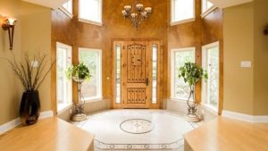 A large octagonal entryway with a high ceiling and an octagonal rug on the floor