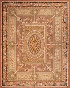 A flat weave petit point wool rug with French Aubusson design in pastel and light brown colors. Rug size 7.10x10