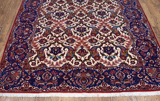 Rug 2429- An enchanting fine antique carpet from Isfahan, with luminous blues and vases of flowers gracing its elegant borders. Rug size 5.3x7.2. 