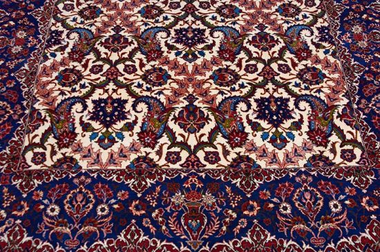 Rug 2429- An enchanting fine antique carpet from Isfahan, with luminous blues and vases of flowers gracing its elegant borders. Rug size 5.3x7.2. 