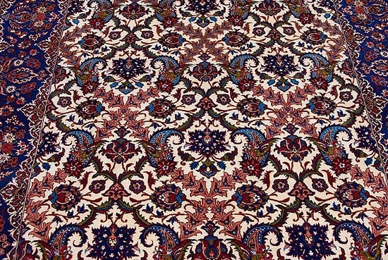 Rug 2429- An enchanting fine antique carpet from Isfahan, with luminous blues and vases of flowers gracing its elegant borders. Rug size 5.3x7.2. 