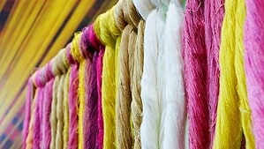 Samples of silk fiber in white and brown colors in the baskets.