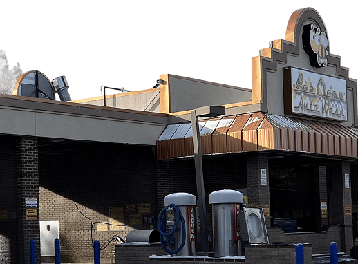 Automatic car wash bay with modern equipment and signage at Bee Clean Auto Wash.