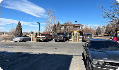 Automatic car wash and detailing station at Bee Clean Auto Wash, featuring state-of-the-art equipment and multiple bays, offering professional vehicle cleaning services in a customer-friendly environment.