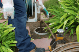 Garden maintenance with planting and tools at Blue Box Self Storage facility.