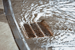 Drain cover in water at Blue Box Self Storage facility.