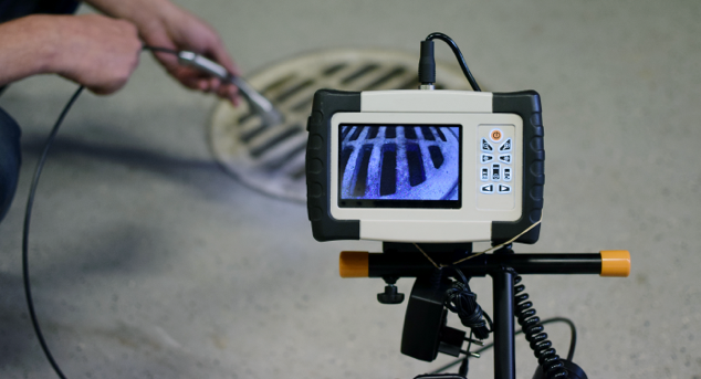 Drone inspecting a storage tank for maintenance and safety checks.