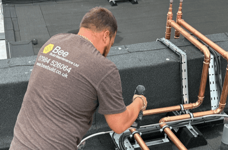 Bee Maintenance Employee drilling copper pipe work