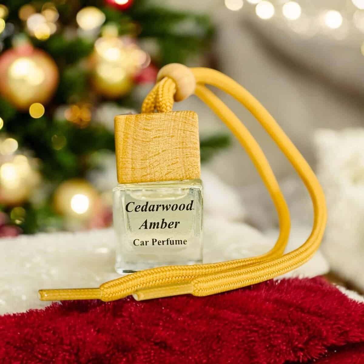 Cedarwood Amber car diffuser with wooden cap and yellow cord, ideal for freshening up your vehicle.