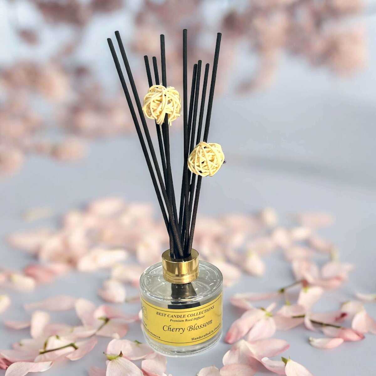 Reed diffuser with cherry blossom scent and decorative black reeds. Perfect for creating a calming f.