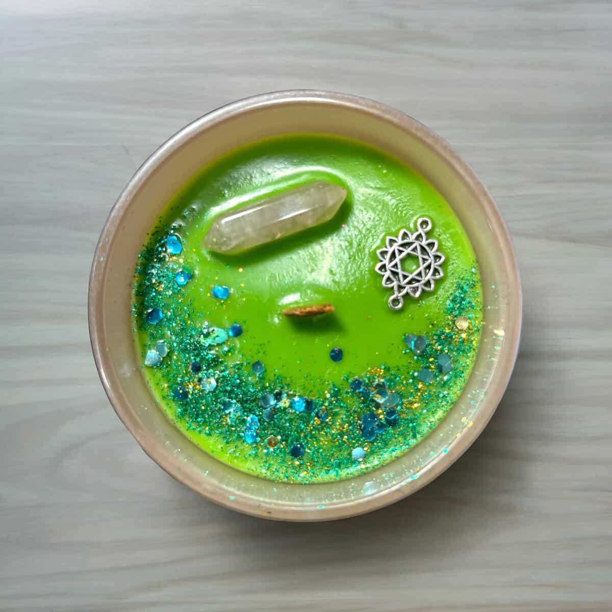 Grounding and stability meditation candle with crystals and glitter.
