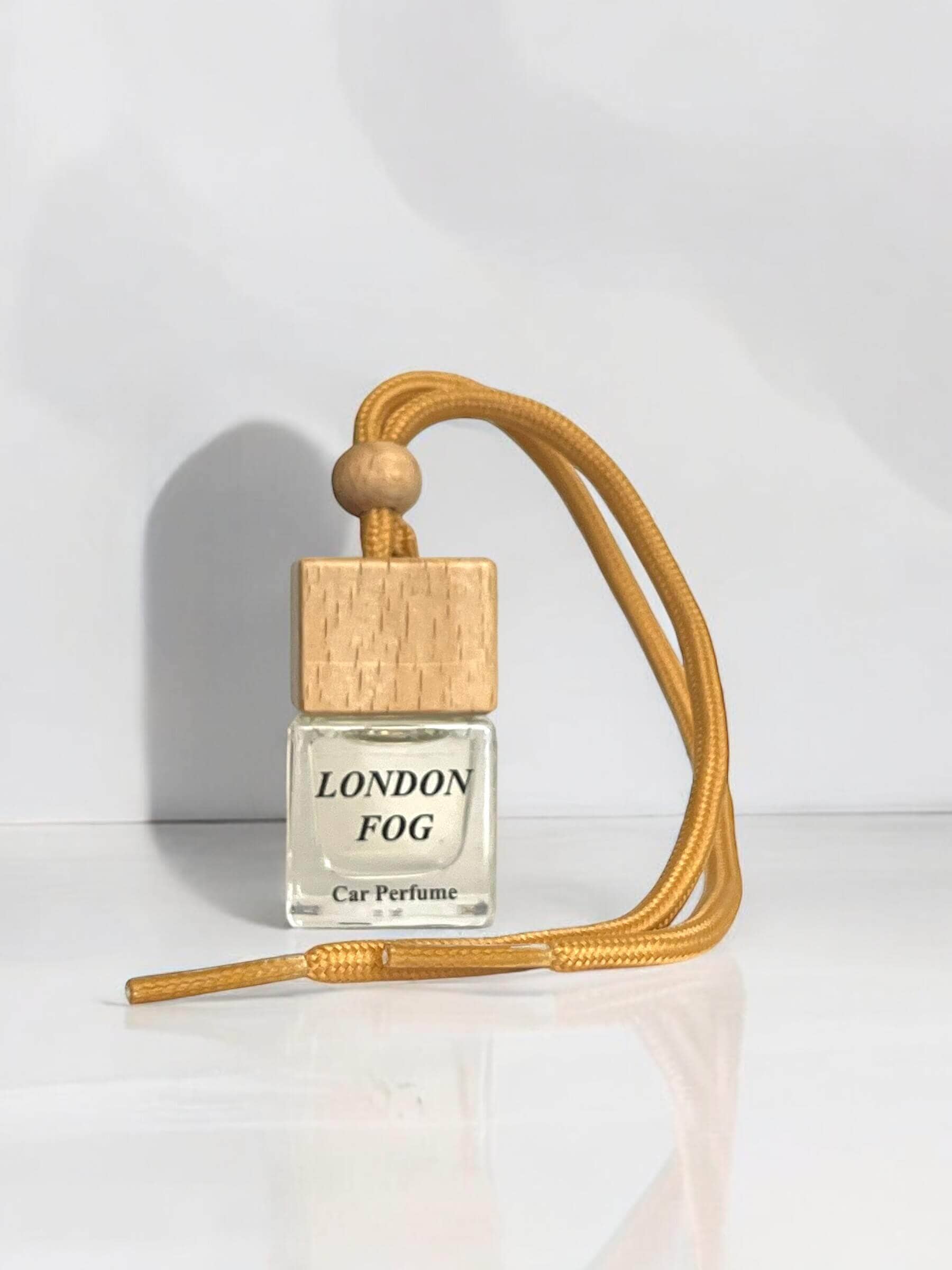 Car diffuser with London Fog scent and wooden cap, featuring a beige lanyard.