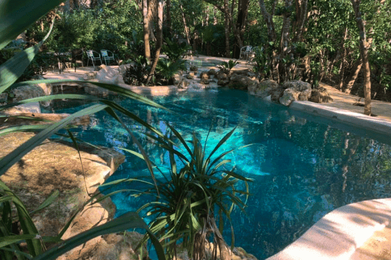 Relaxing outdoor pool surrounded by lush greenery at La Hacienda Cancun.