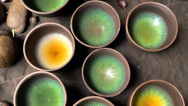 Artistic eye designs in small bowls, symbolizing spiritual visions in Ayahuasca retreats.
