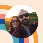 Happy couple enjoying nature at a retreat, showcasing relaxation and wellness.