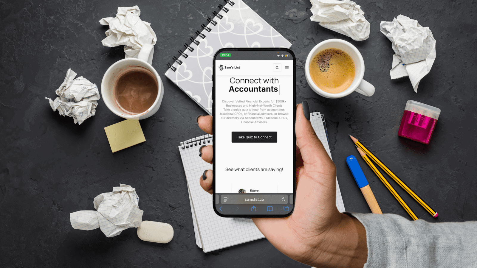 Person holding smartphone with "Connect with Accountants" on screen, surrounded by crumpled paper an.