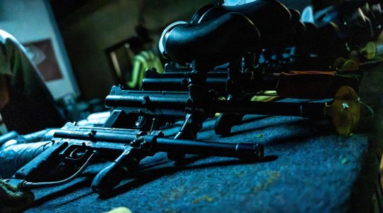 High-powered rifles and tactical gear displayed on a dark surface, emphasizing a bold, rugged, and adventurous aesthetic suitable for Big Balls Brotherhood branding.