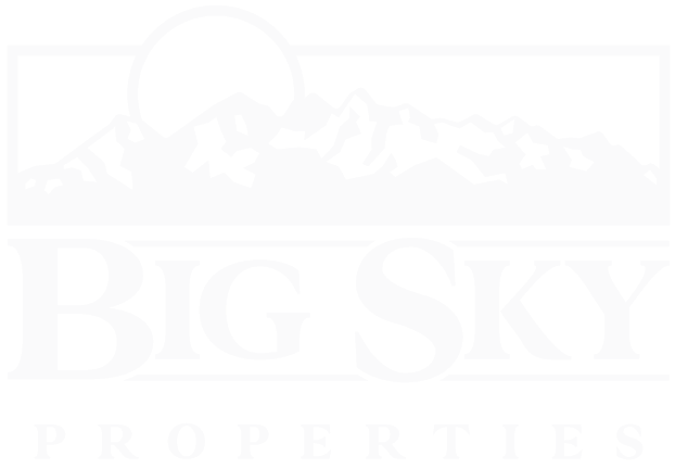 Scenic Montana mountain landscape with Big Sky Properties of Montana signage in foreground.