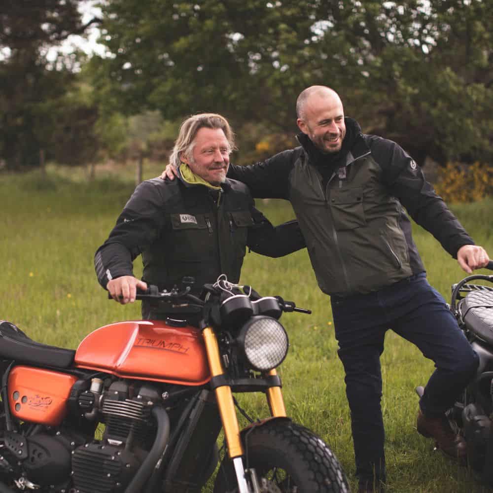 Charley Boorman and his custom Triumph Thruxton on bikerbnb adventure, The Highland Scramble, wearing Belstaff