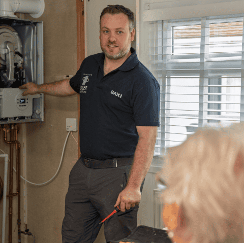 boiler service engineer pointing in a boiler