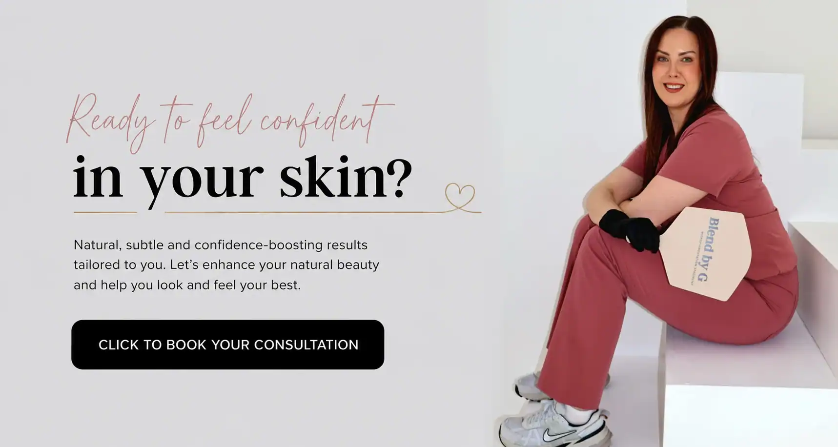Woman in pink medical scrubs smiling, promoting skincare confidence at Blend by G clinic.