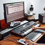 Sound engineer in headphones working and mixing music indoors in the studio.