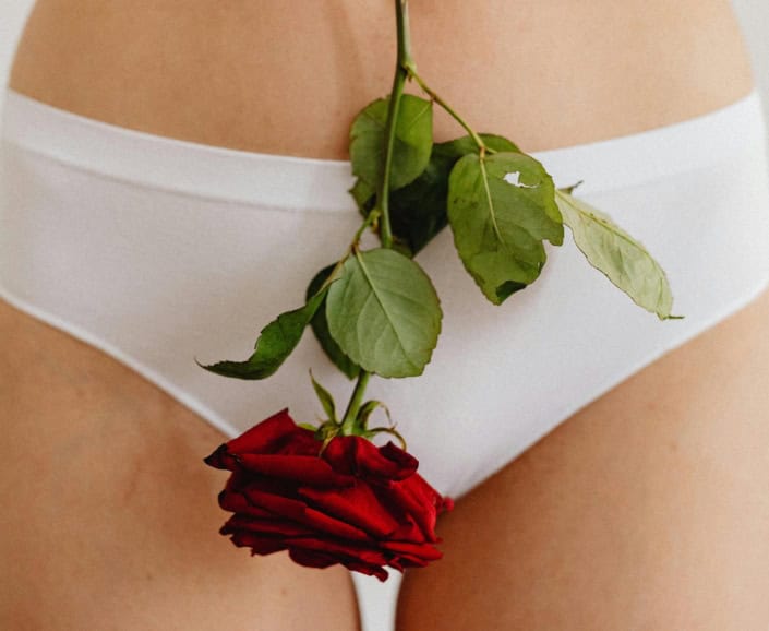 a rose on a woman's bottom