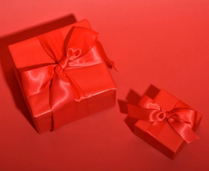 a red gift boxes with a bow