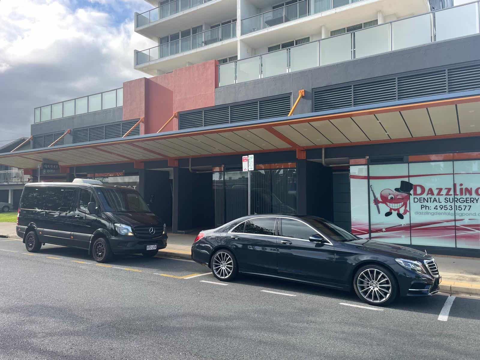Mercedes-Benz vehicles parked outside Dazzling Dental Surgery, showcasing Blue Diamond Transfers' luxury transport services.