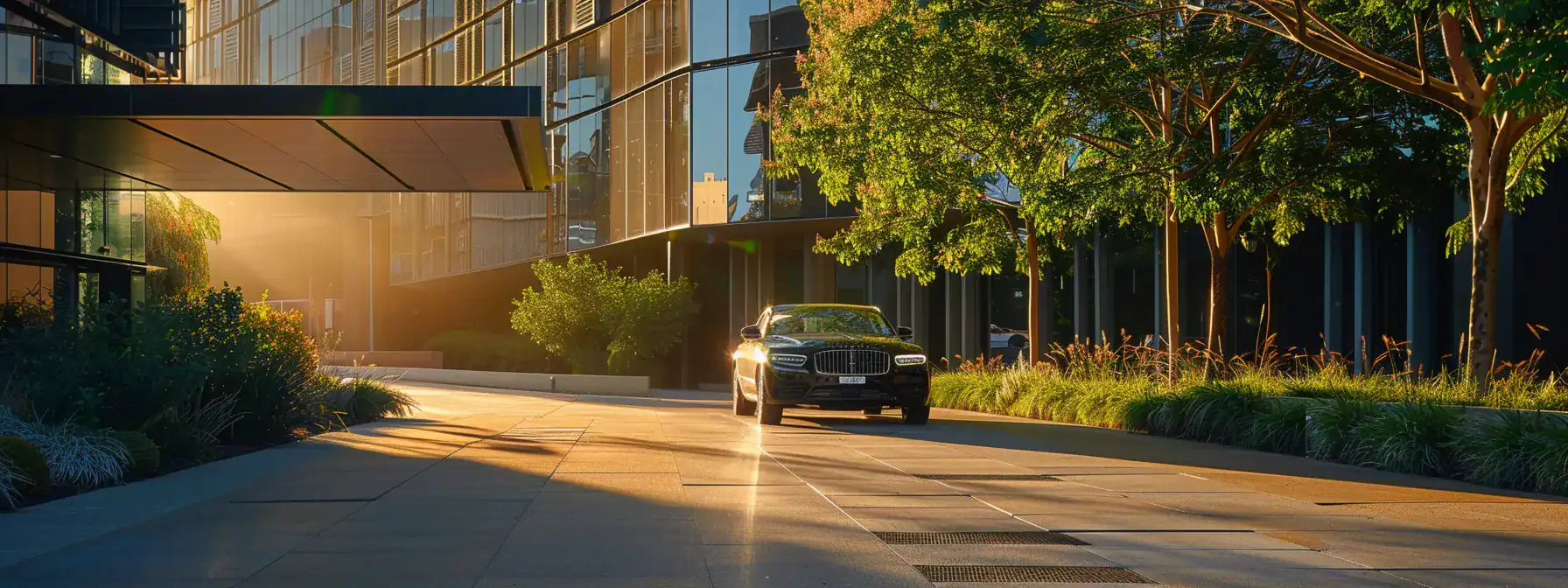 a sleek, luxury vehicle awaits in front of a modern corporate building, exuding professionalism and sophistication, illuminated by soft morning light that reflects the promise of seamless travel for executives in sydney.