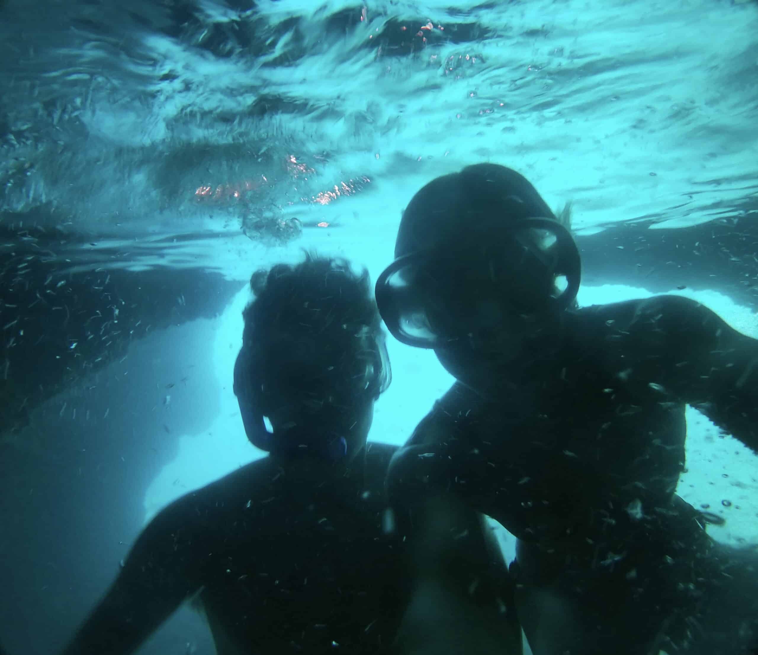 Couple Diving in the Blue Cave: Embracing Underwater Adventure