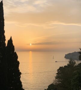 Sunset Over Dubrovnik's Old City and Sailing Boat on Adriatic Sea
