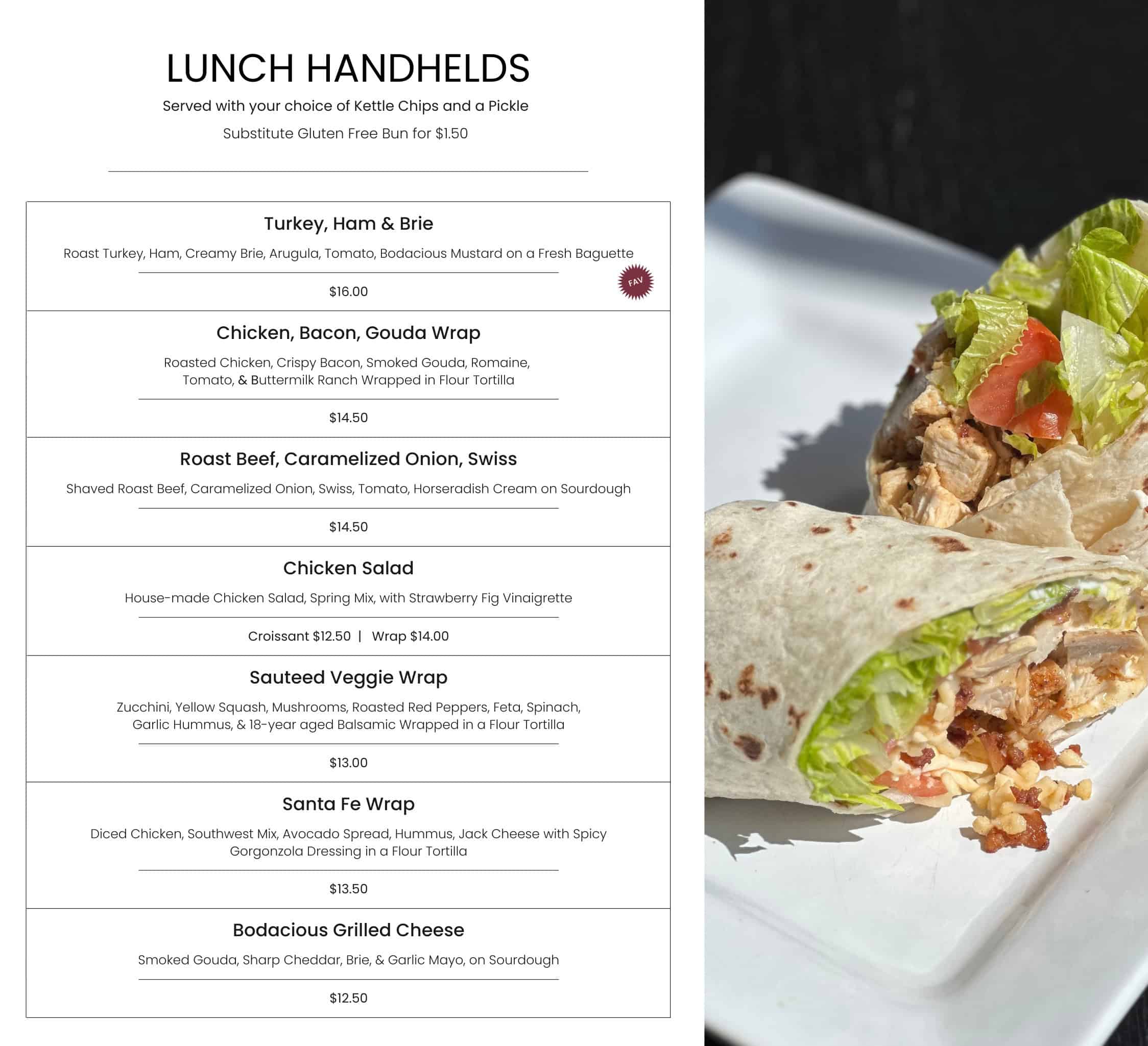Freshly made chicken and vegetable wrap with lettuce, tomato, and cheese, served with kettle chips and a pickle at Bodacious Shops.