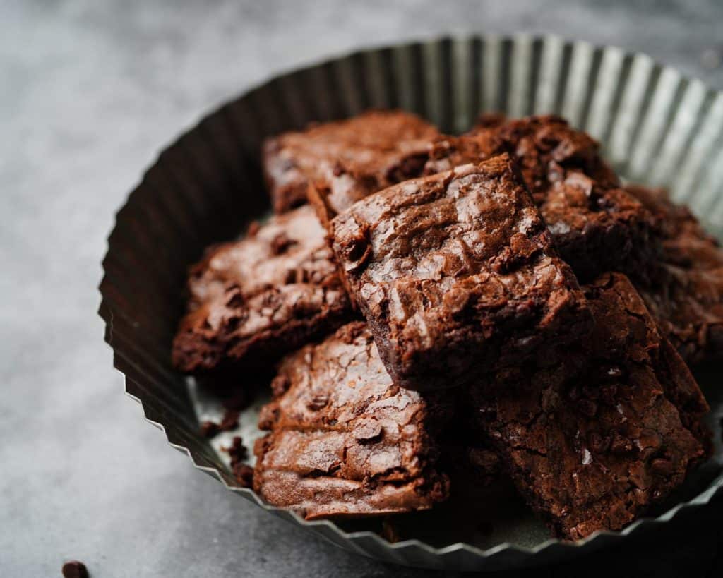 Rich, fudgy chocolate brownies in a black baking dish, perfect for dessert or snacking, showcasing indulgent homemade treats.