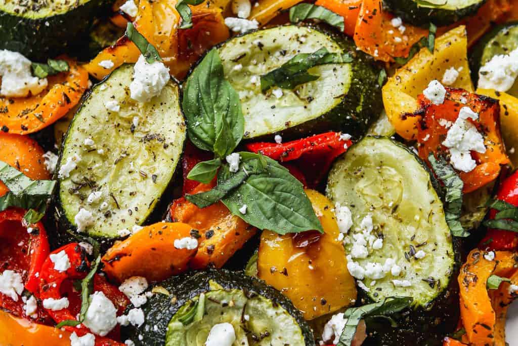 Fresh roasted vegetables including zucchini, bell peppers, and basil, ready for culinary use, featured on Bodacious Shops website.