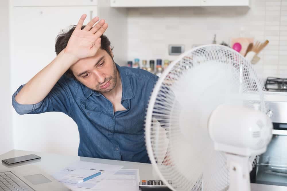 June Bonfe Insider image, man using fan to cool off