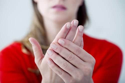 Woman with red sweater holding hands