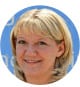 A cheerful person with short blonde hair smiles confidently against a light blue background, embodying the spirit of exciting opportunities in HVAC careers.