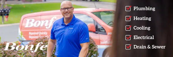 A man in a blue polo stands outside a Bonfe service van, ready to ensure quality. A list on the right highlights services: Plumbing, Heating, Cooling, Electrical, Drain & Sewer—all with red checkmarks. Don't miss out on our current discount for any repair or replacement service!.