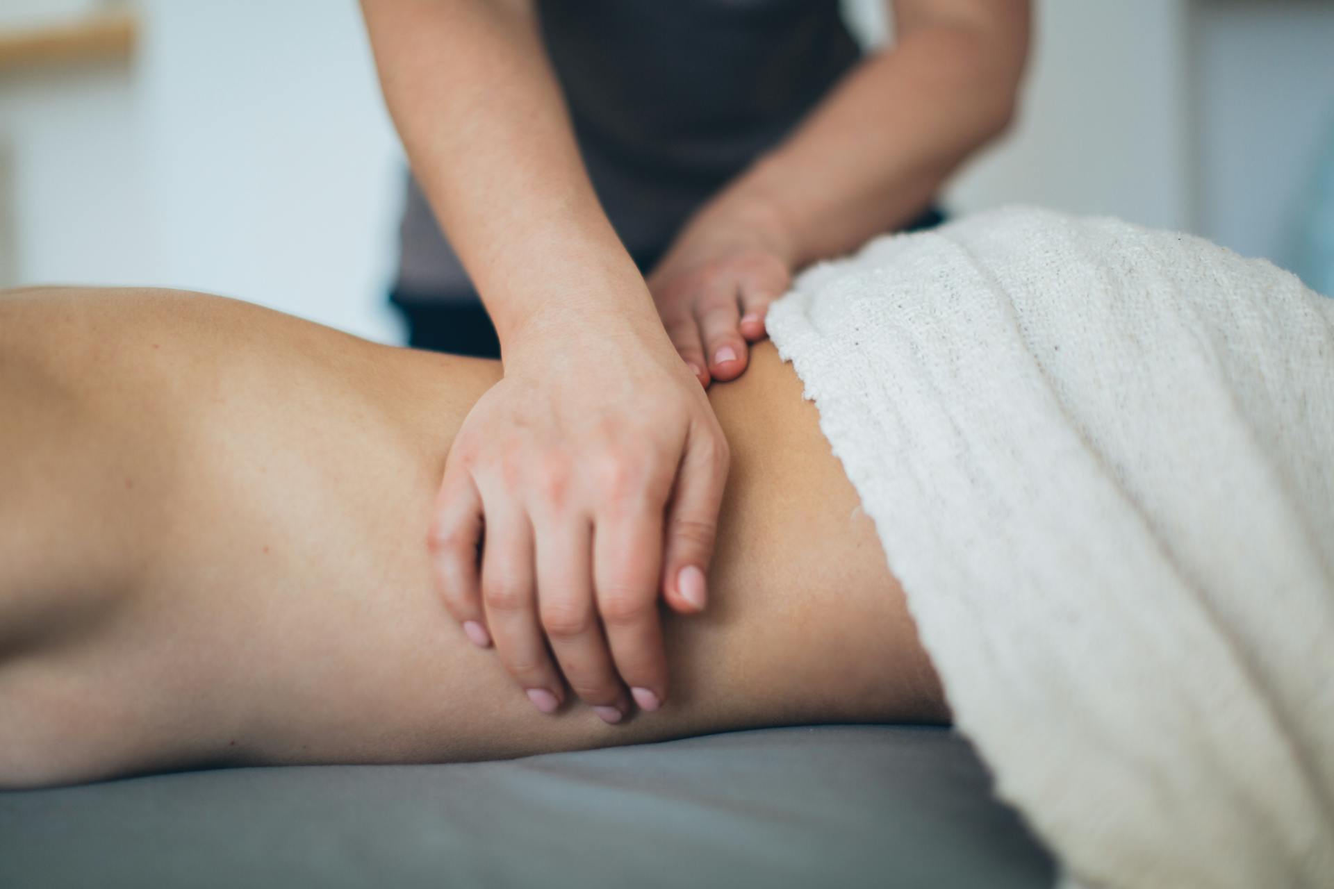 Massage therapist treating soft tissue injury to relieve tension and promote healing.