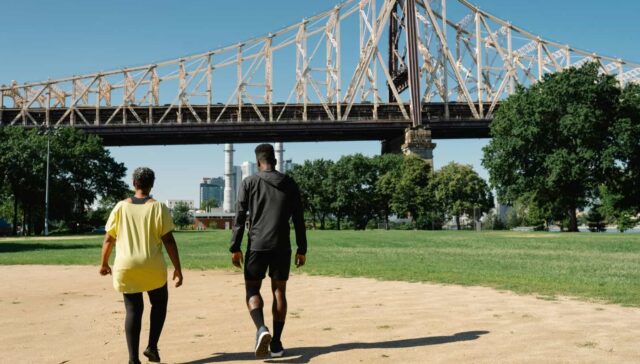 Bright sunny day at Bay-O-Vista Swim & Tennis Club, featuring outdoor activities, tennis courts, and scenic views of bridges and city skyline for recreation and community events.