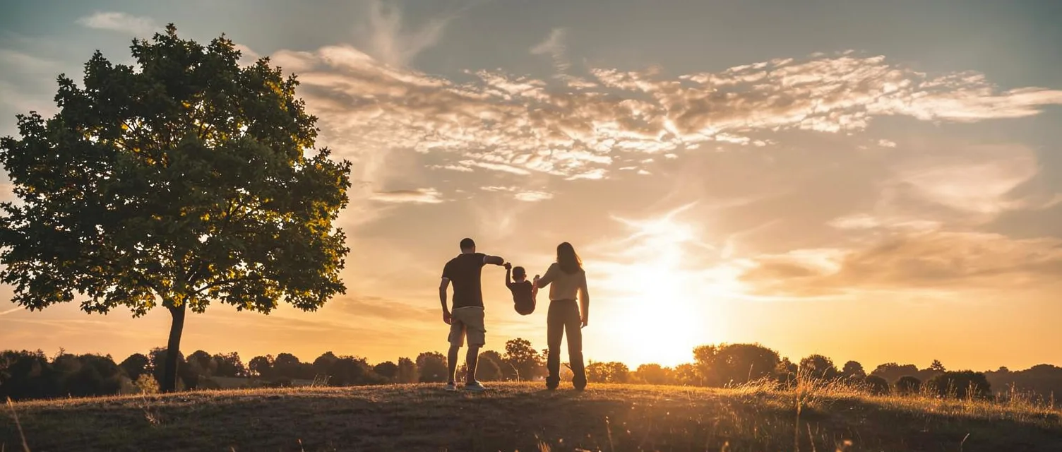 Family enjoying an active outdoor day together at sunset