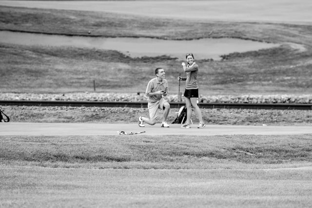Black and white photo of two people playing a game of frisbee captured by a La Crosse Proposal Photographer.