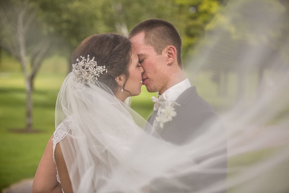Bride and Groom under Veil at Cedar Creek Golf Club