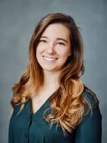 A portrait of a woman representing "About us" in a green shirt.