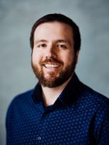 One of us sports a beard and a blue shirt.