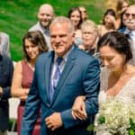 Courtney walks down the aisle with James at their love-filled backyard wedding.
