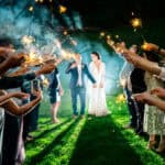 A love-filled backyard wedding with Courtney and James holding sparklers.